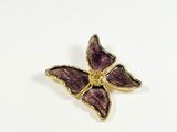 purple enamel butterfly pin with gold accents on a white background