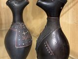 two vases that are on display in a glass case