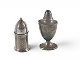 two salt and pepper shakers sitting next to each other