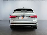 the rear end of a white audi suv parked in a garage