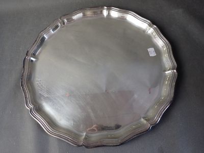 a silver plate on a table with a black table cloth