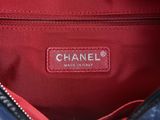a close up of a chanel bag with a tag on it