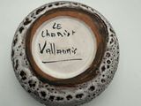 a brown and white vase with writing on it
