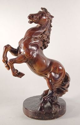 statue en bronze représentant un cheval dressé sur ses pattes arrière, posée sur un socle