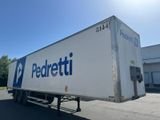 the back of a semi truck parked in front of a building