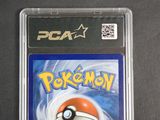 the pokemon card is in a clear plastic holder on a table