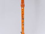 an orange flute on a white surface with a white background