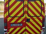 a yellow and red van parked on the side of the road