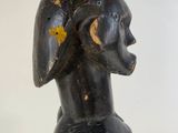 an image of a wooden statue of a woman with a helmet on it ' s head