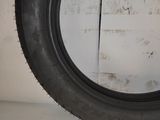 a close up of a tire on a shelf in a room