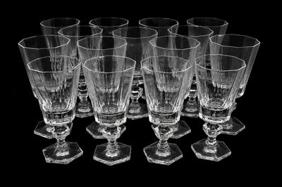 six empty wine glasses sitting on a black surface