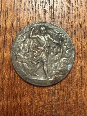 a close up of a silver coin on a wooden surface
