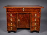an antique mahogany desk with four drawers and brass handles