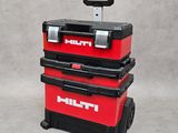 two red tool boxes sitting on top of each other on a gray surface