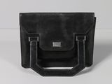 a black leather bag with a metal handle on a white surface