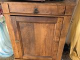 a wooden cabinet with a sewing machine on top of it