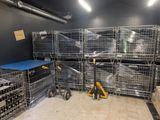 a room with many cages and a table in it
