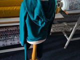 a mannequin with a hoodie on it in front of a bed