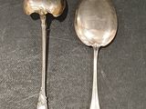 two spoons that are sitting on a table