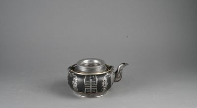 une théière ancienne en argent, avec un couvercle et une anse
