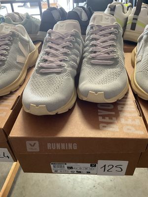 several pairs of running shoes are on display in a store