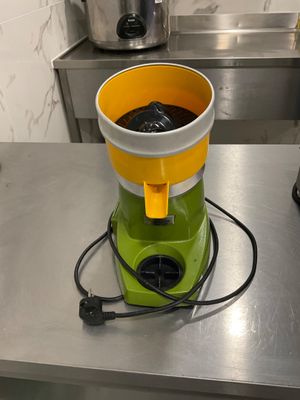 a green and yellow blender sitting on a counter
