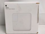 an apple power adapter box sitting on top of a white table