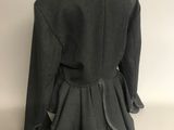 the back view of a black jacket with ruffles on a mannequin mannequin mannequin mannequin mannequin mannequin mann