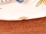 a white plate with a blue and white flower design on it