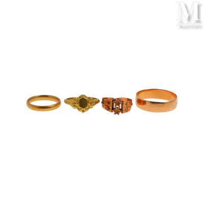three gold rings and a ring with a stone in the middle