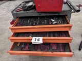 une boîte à outils rouge posée sur un coffre à outils rouge