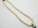 gros plan d'un collier de perles sur une surface blanche