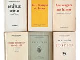 plusieurs livres sont empilés sur une surface blanche