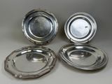 three silverplated dishes on a table, one with a lid and the other with a silver plate