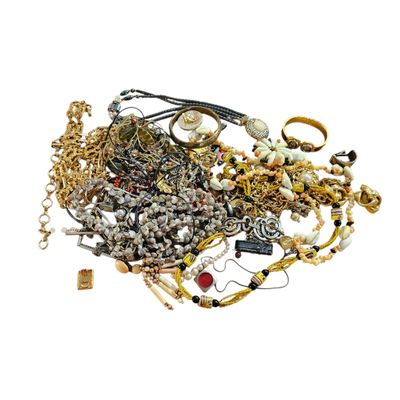 a pile of gold and silver jewelry on a white background