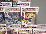 boxes of various anime figurines are stacked on top of each other