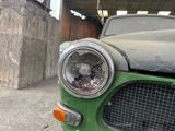 a green car that is parked in a garage
