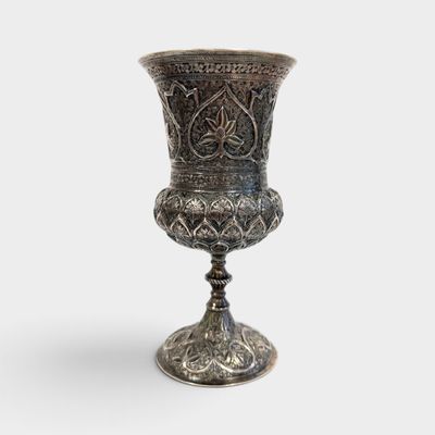 an image of a silver vase sitting on top of a table