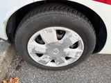 a close up of a tire on a white car