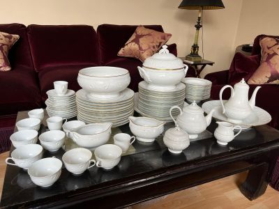 a table that has a lot of white dishes and cups on it