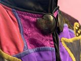 a close up of a purple and purple jacket on a mannequin