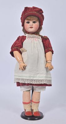 an image of a doll with a red hat and white dress