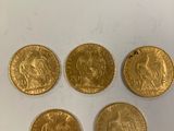 quatre souverains d'or, dont l'un représente un lion et l'autre un lion