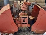 a red bulldozer that is sitting in a pile of wood