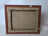 an old picture frame with a piece of fabric in it