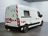 a white van with red and black stripes parked in a room