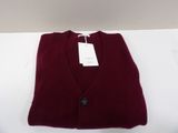 a close up of a red sweater with a tag on it