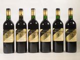 six bouteilles de vin sont alignées sur une surface blanche