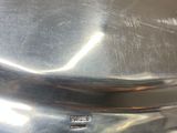 a metal pan with a handle on a table