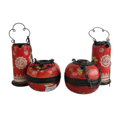 two red vases with chains hanging from them on a white background